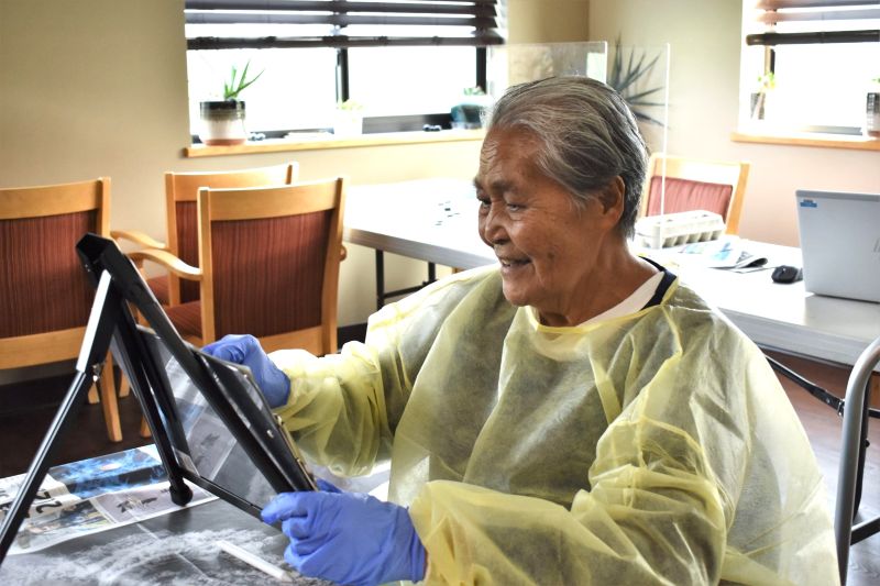 An older adult practices drawing with charcoal at the Idaho State Veterans Home in Lewiston.