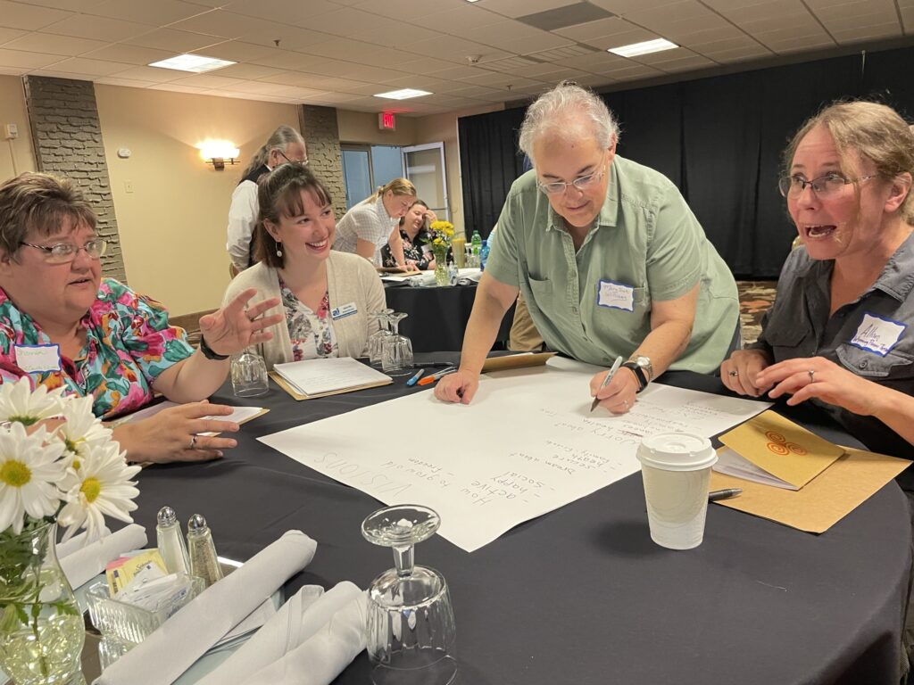 A library worker brainstorms with colleagues at a training in wyoming