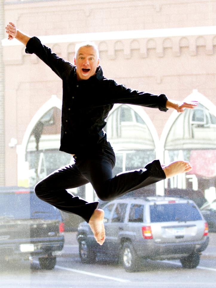 Dance instructor David DeBlieck leaps across the studio floor.