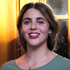 Headshot of Gahlia Eden. She has long straight hair that's dark on the top and lighter at the ends. She has dark colored eyes and is smiling.