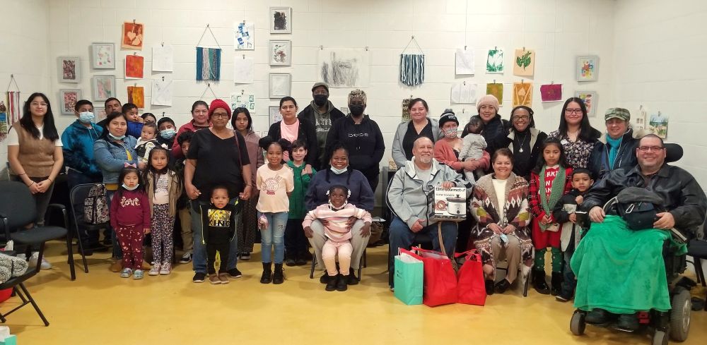A group photo of older adults and children smiling.