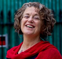 This is a headshot of teaching artist, Robin Bady. She has short brown hair and is smiling.