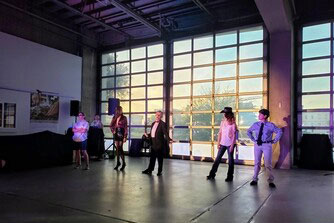An intergenerational performance with older adults and younger people dressed in drag.