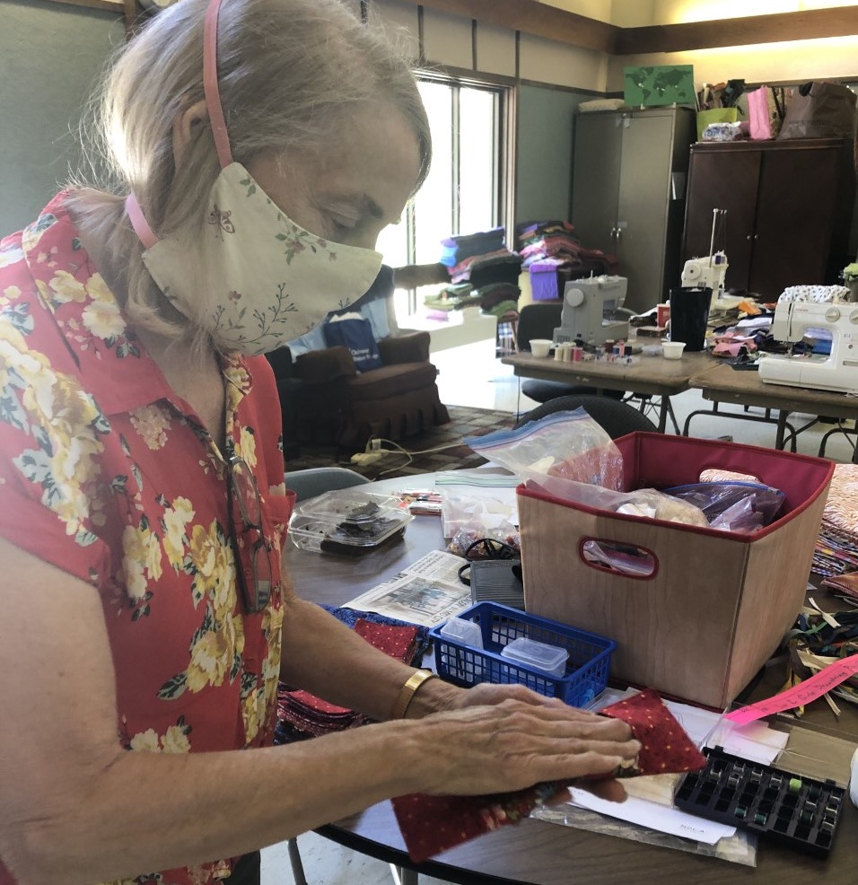 An older adult sewist creates surgical gowns for local hospitals in Baton Rouge.