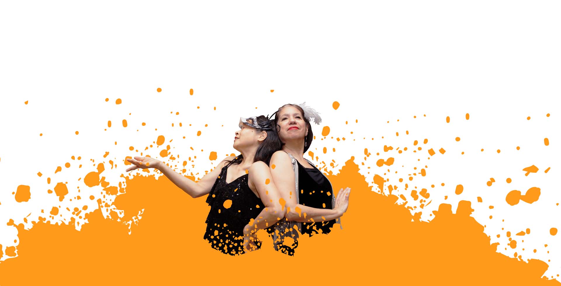 Two older women dancers pose back-to-back wearing costume. Orange paint splatter surrounds them.